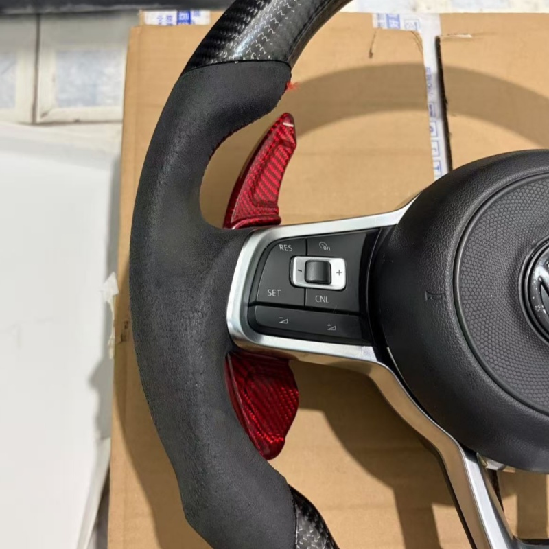 Close-up of stitching on modified Volkswagen steering wheel, ergonomic car tuning component