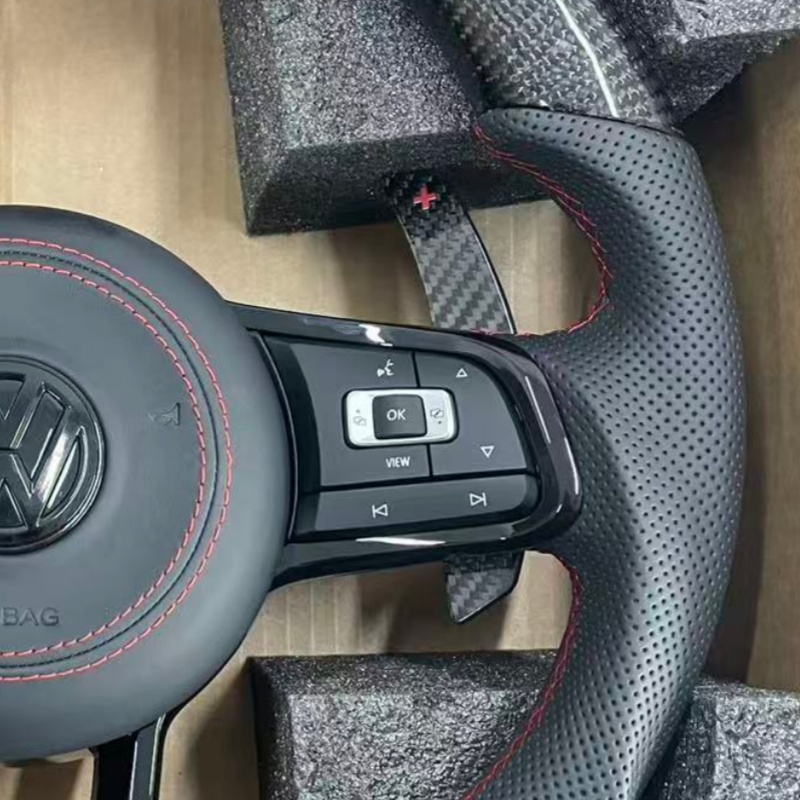 Close-up of stitching on modified Volkswagen steering wheel, ergonomic car tuning component