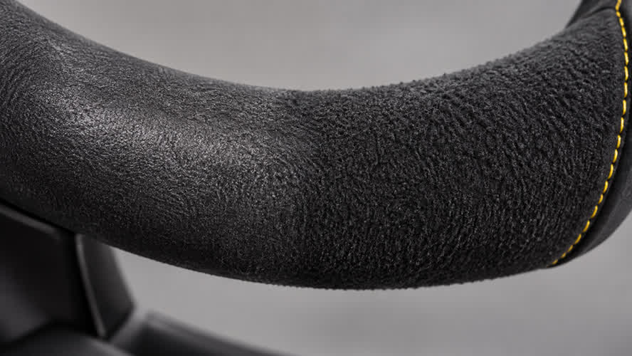 Illustrative charcoal microfiber grip showing flattened nap beside a more raised matte texture