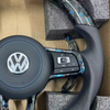 Close-up of stitching on modified Volkswagen steering wheel, ergonomic car tuning component