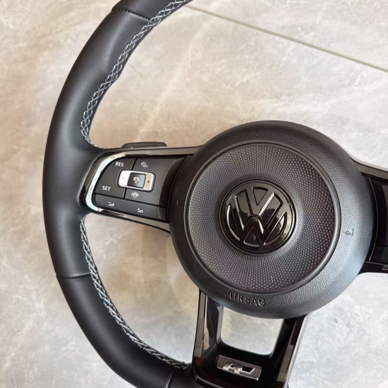 Close-up of stitching on modified Volkswagen steering wheel, ergonomic car tuning component