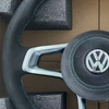 Close-up of stitching on modified Volkswagen steering wheel, ergonomic car tuning component